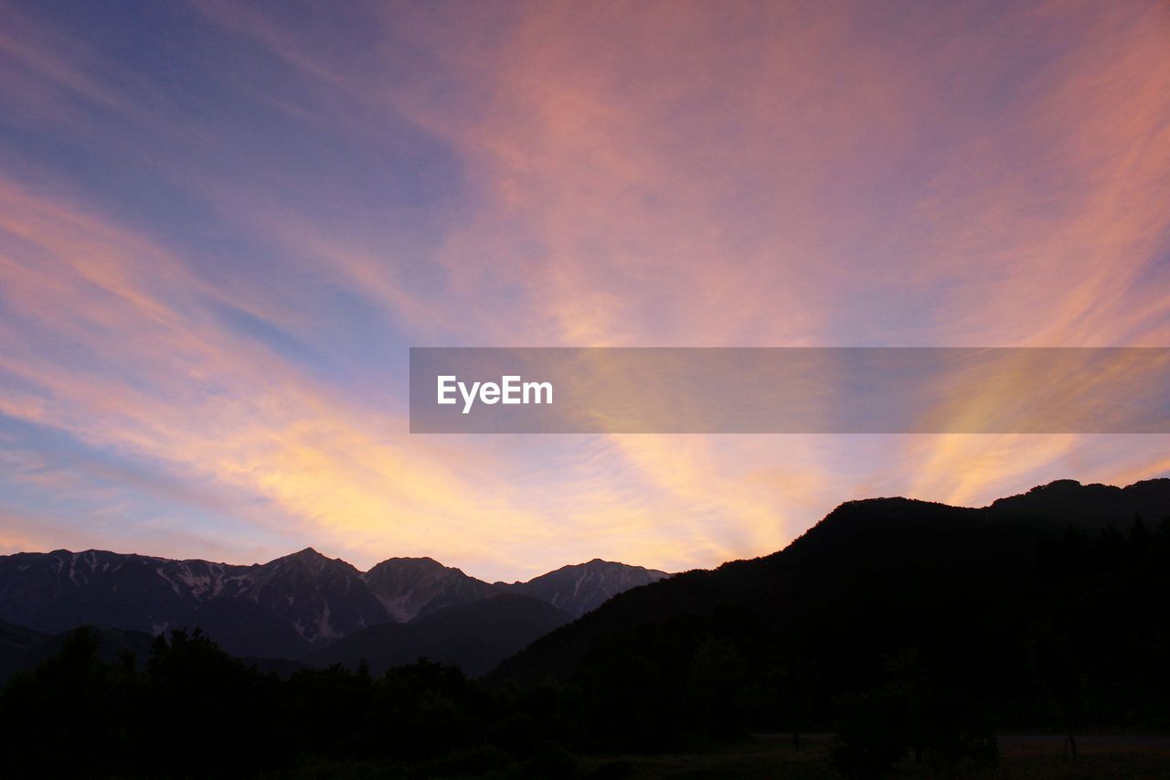 SILHOUETTE MOUNTAINS AGAINST SKY DURING SUNSET