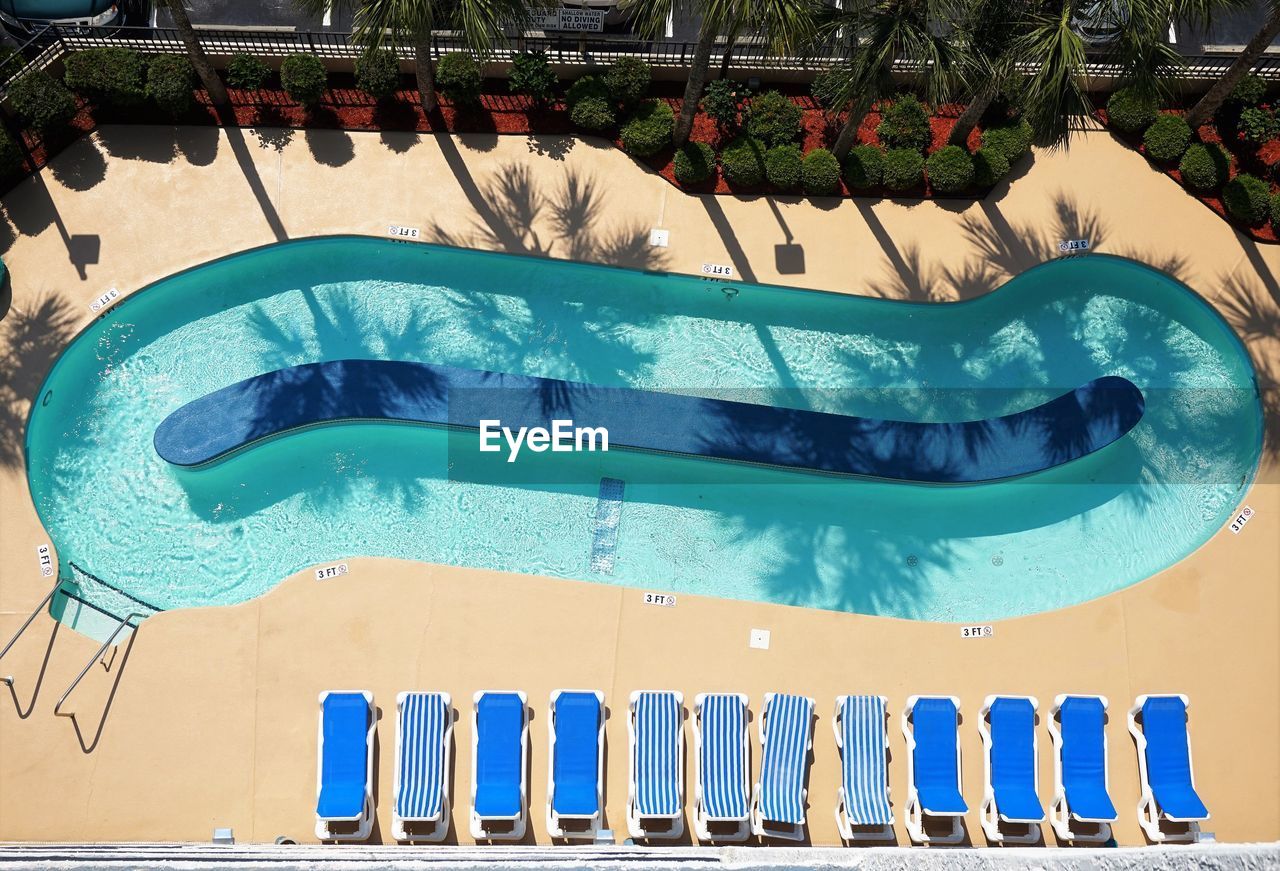 HIGH ANGLE VIEW OF SWIMMING POOL AGAINST BLUE SKY