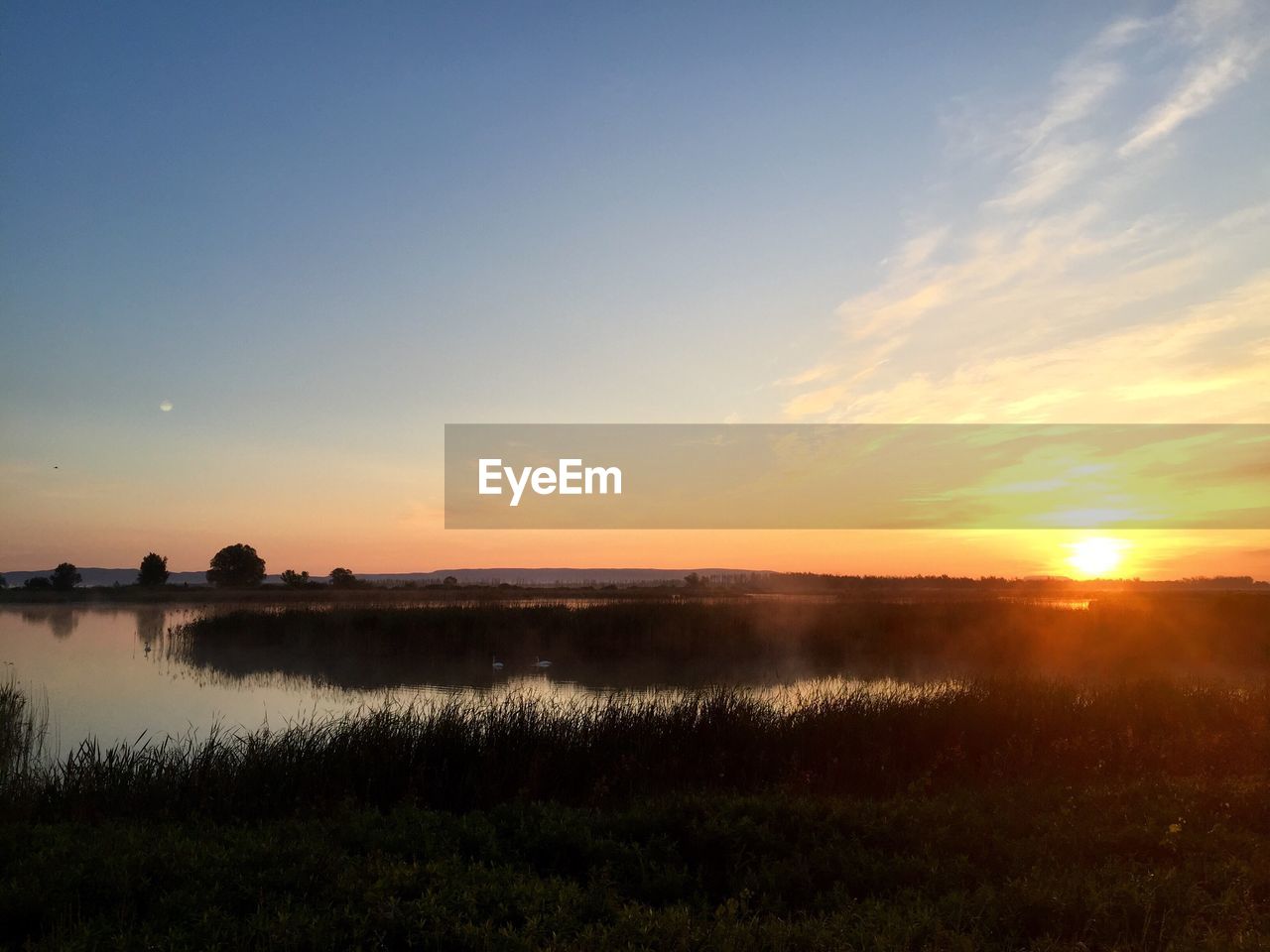 Scenic view of sunset over river