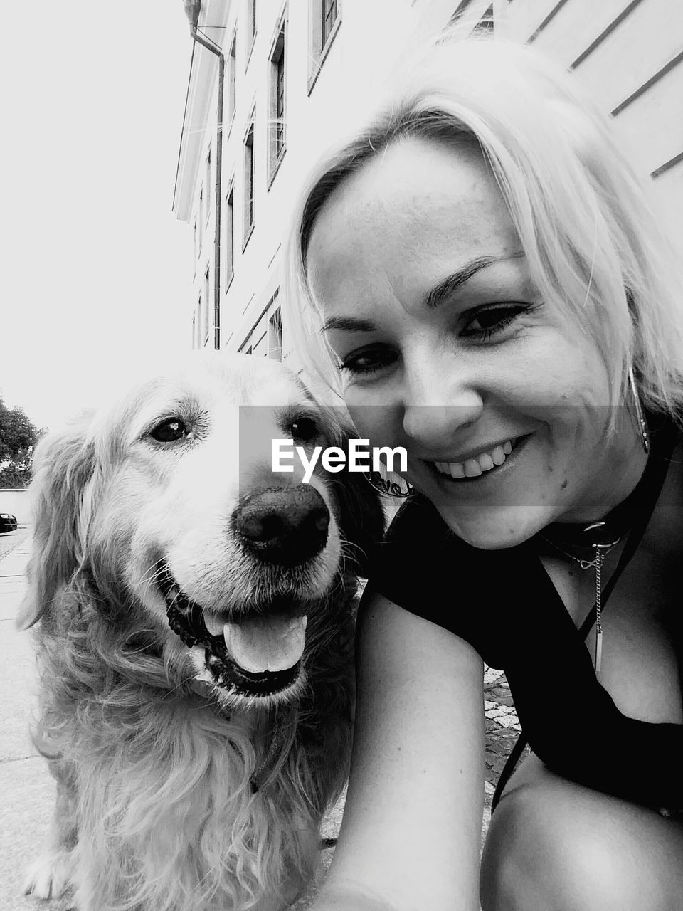 Portrait of smiling woman and golden retriever