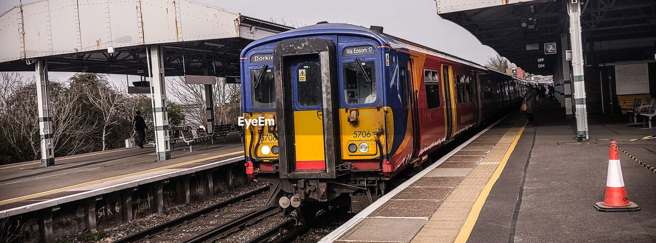 TRAIN ON RAILROAD PLATFORM