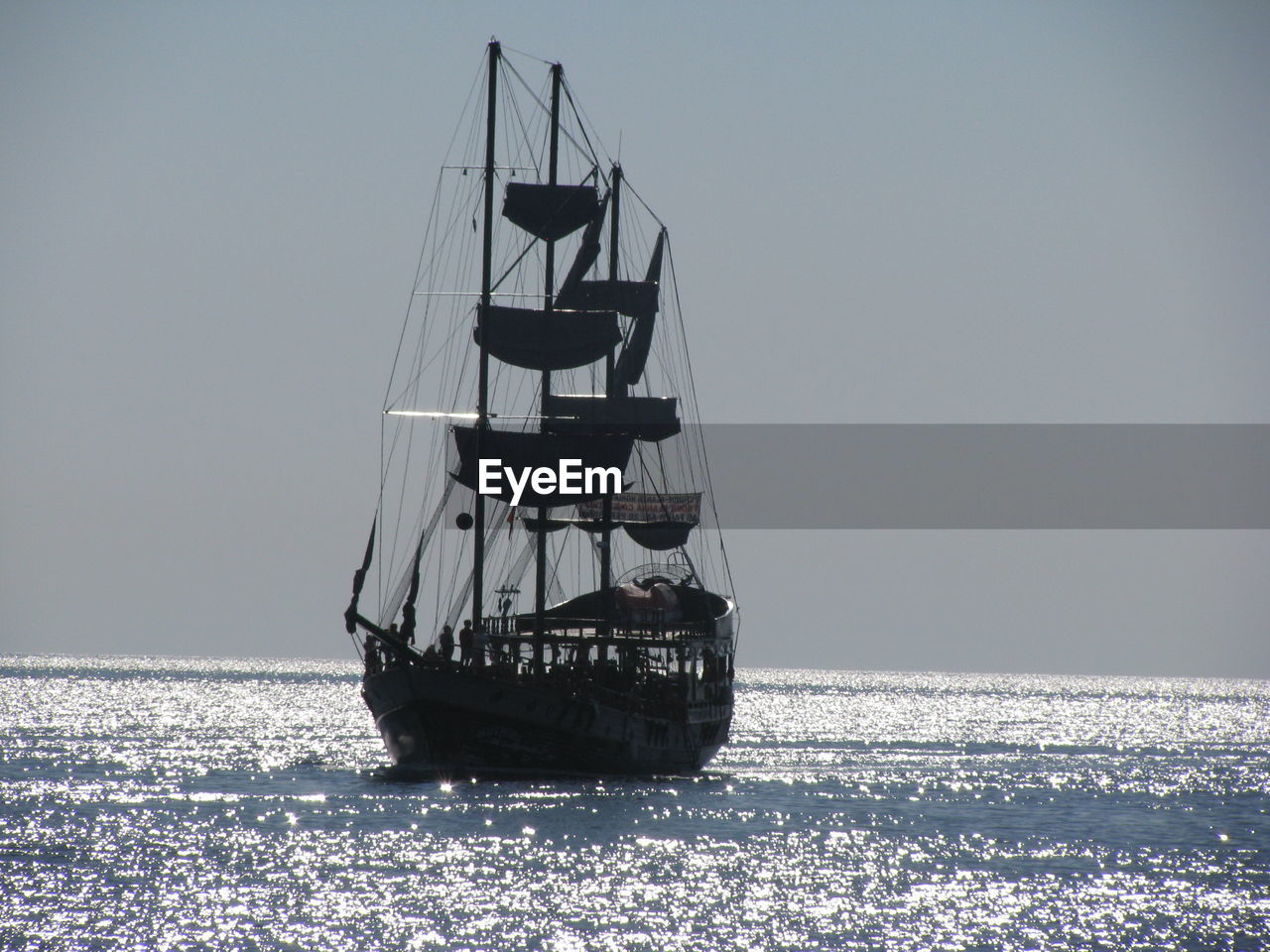 Ship sailing in sea against sky