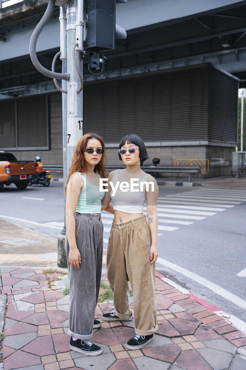 Full length of lesbian couple standing on road