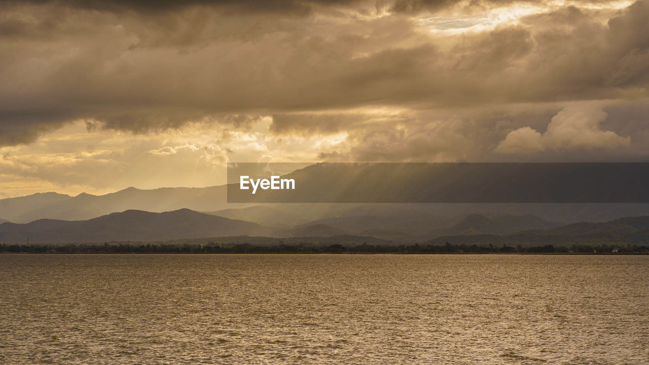 Scenic view of land against sky during sunset