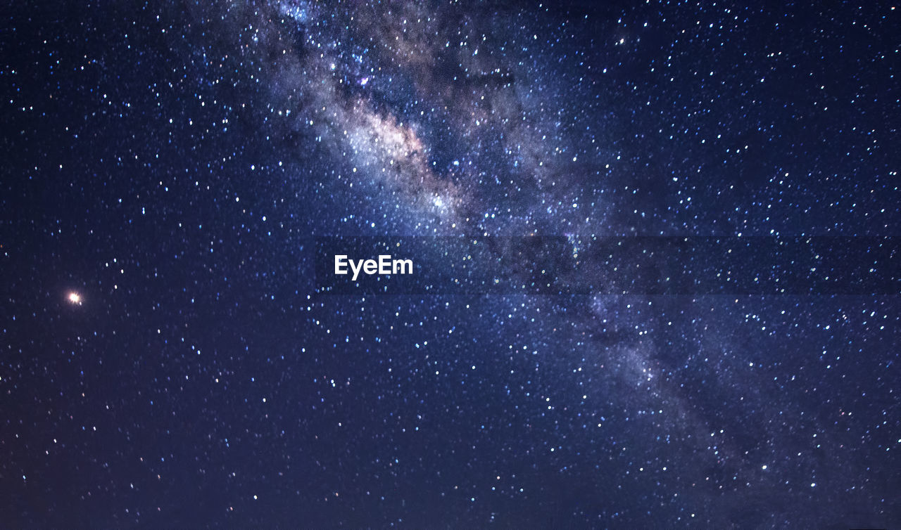 LOW ANGLE VIEW OF STARS AGAINST STAR FIELD AT NIGHT