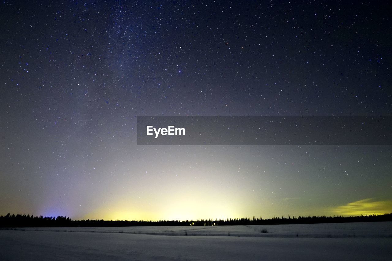 Scenic view of field against sky at night