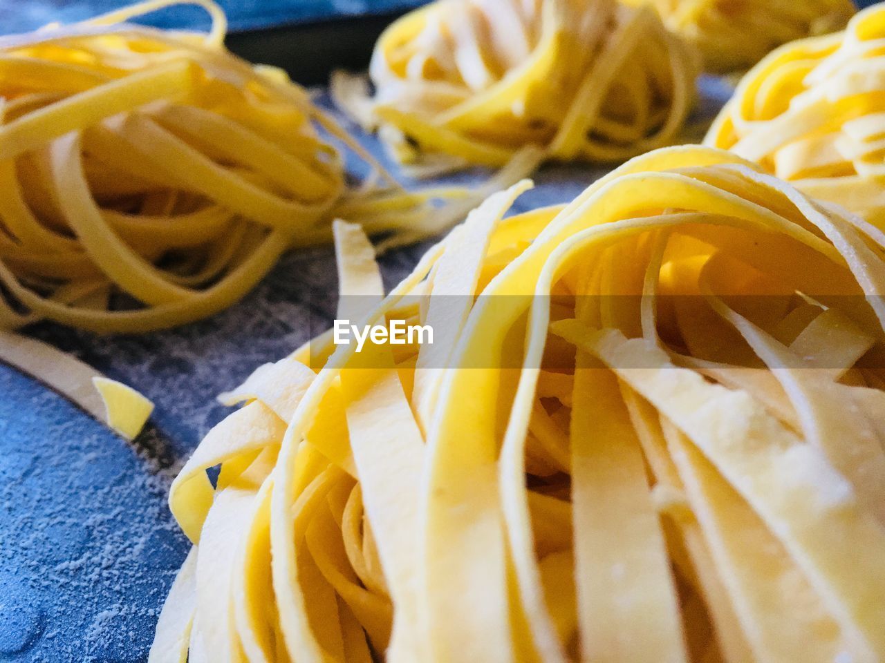 CLOSE-UP OF FRESH YELLOW AND BREAD ON TABLE