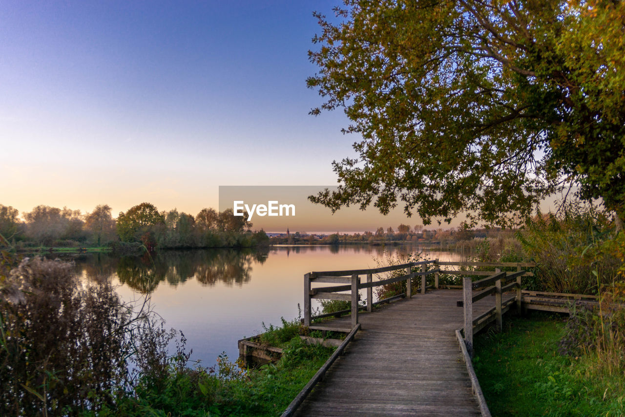 Pier over lake against sky