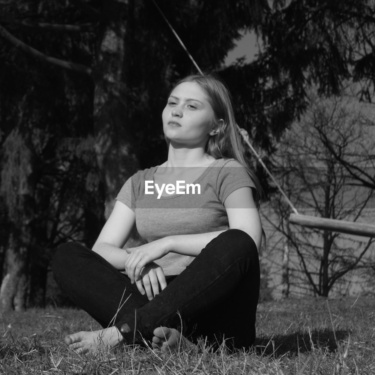 Thoughtful teenage girl sitting on field