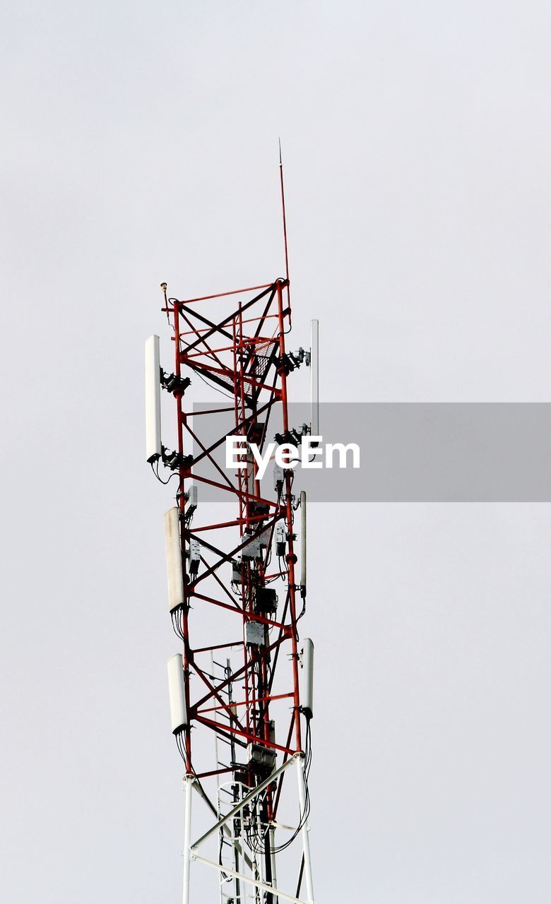 Low angle view of communications tower against sky