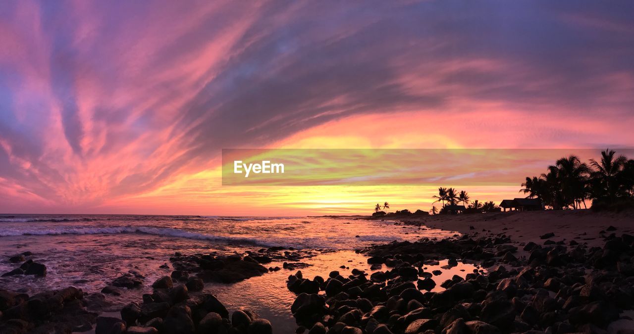 Scenic view of beach against sky during sunset