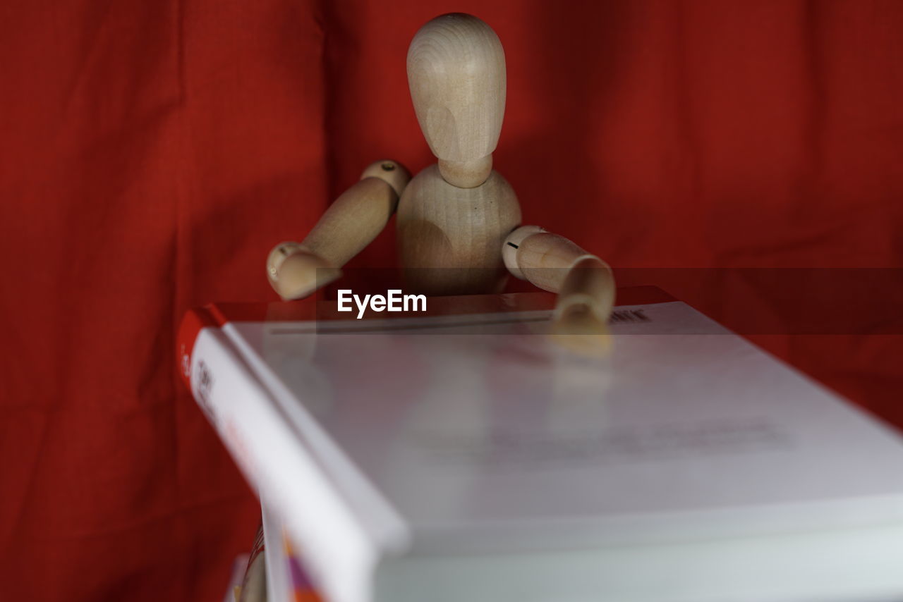 Wooden figurine with open book