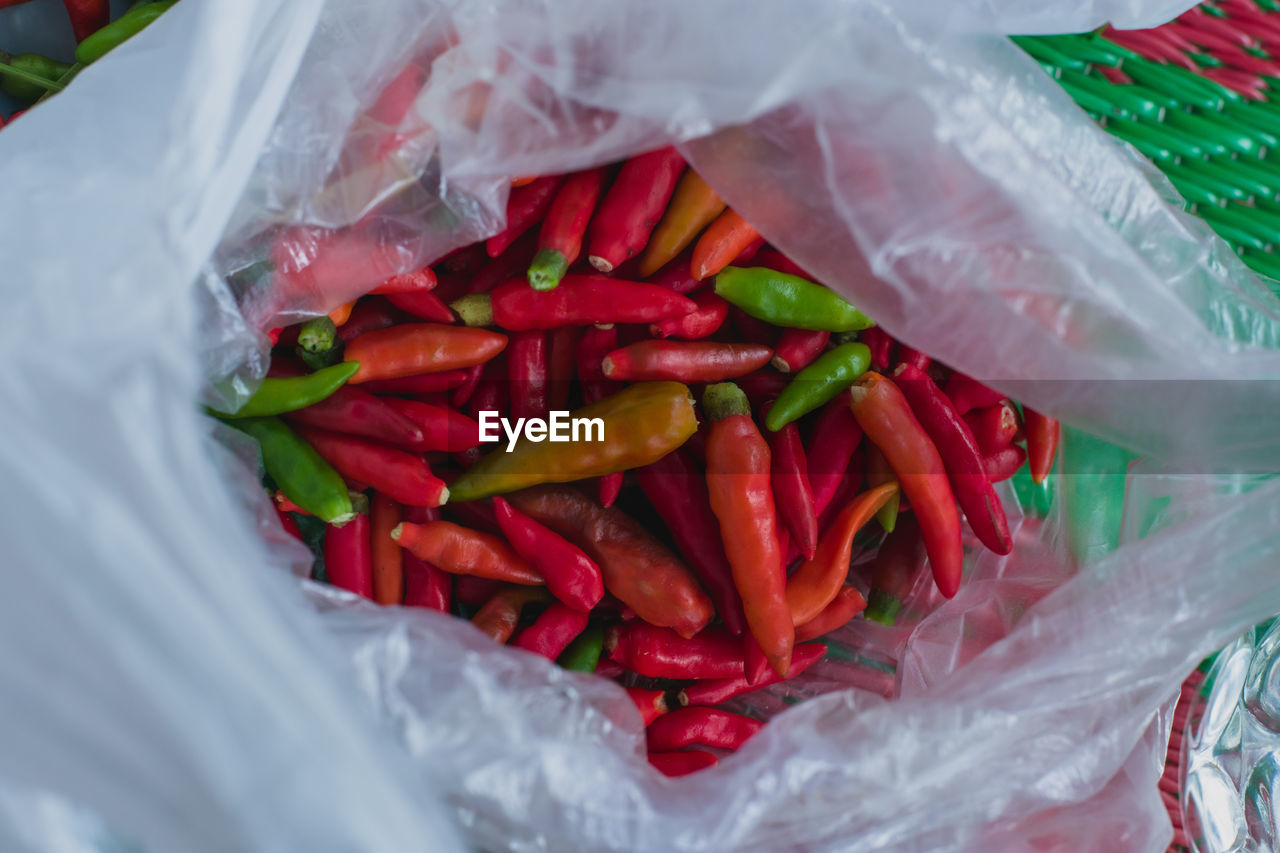 Close-up of red chili peppers in plastic container