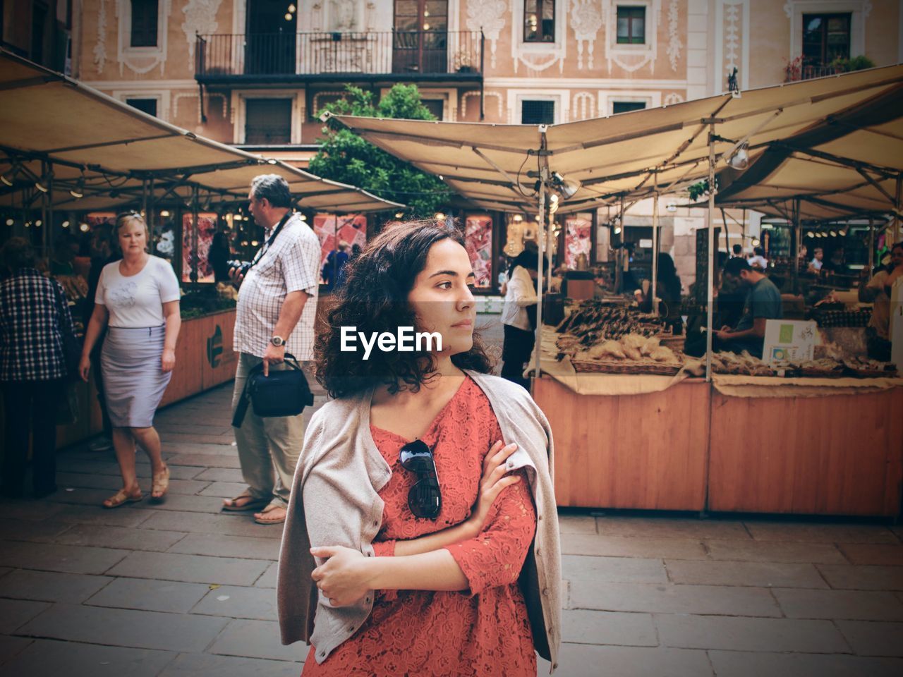 Woman in market against building