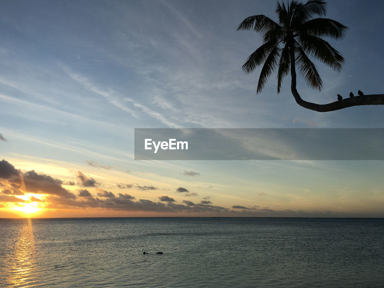 Scenic view of sea against sky at sunset