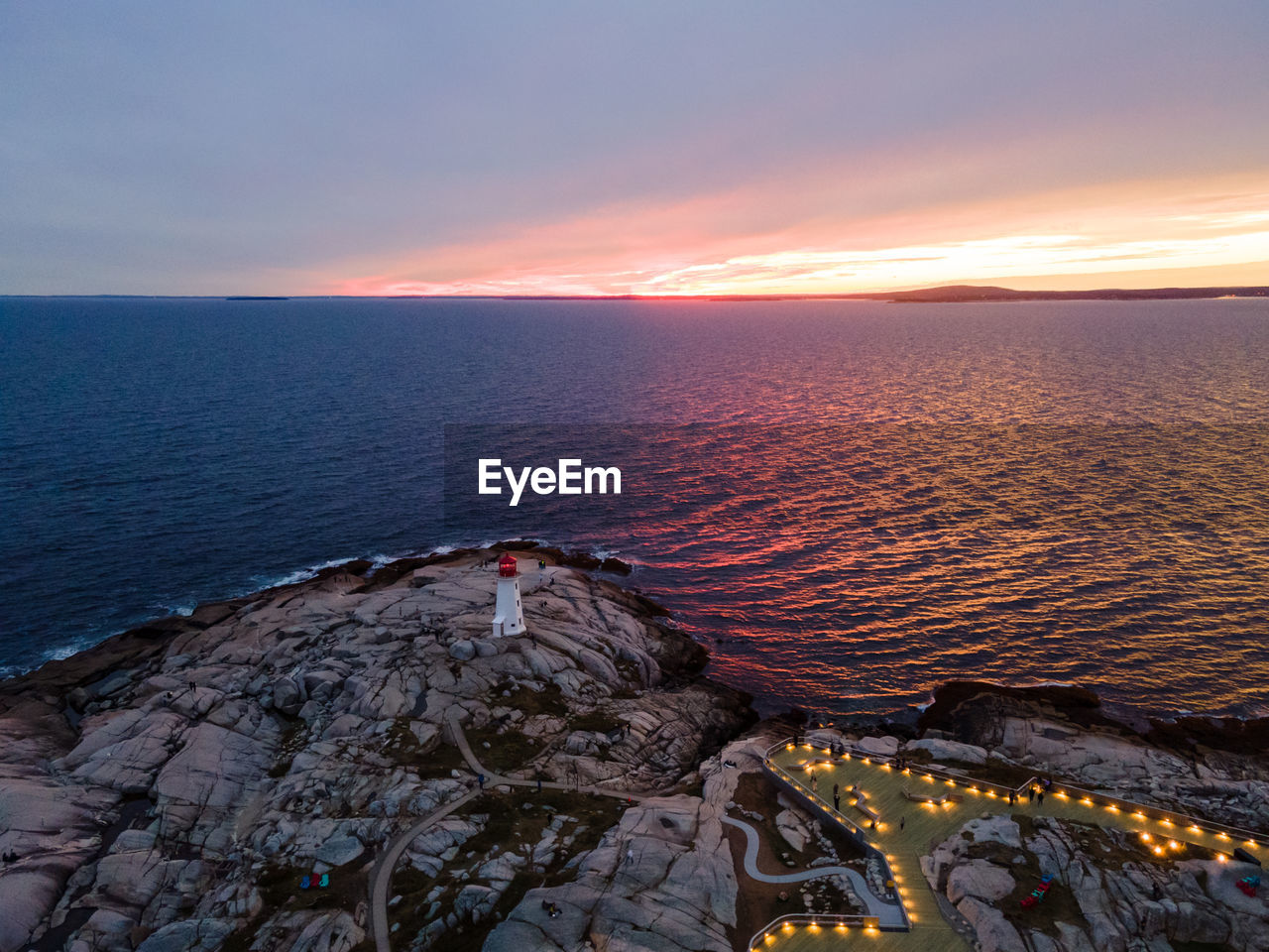 Aerial shot of peggy's point lighthouse and viewing platform at peggy's cove, nova scotia, canada