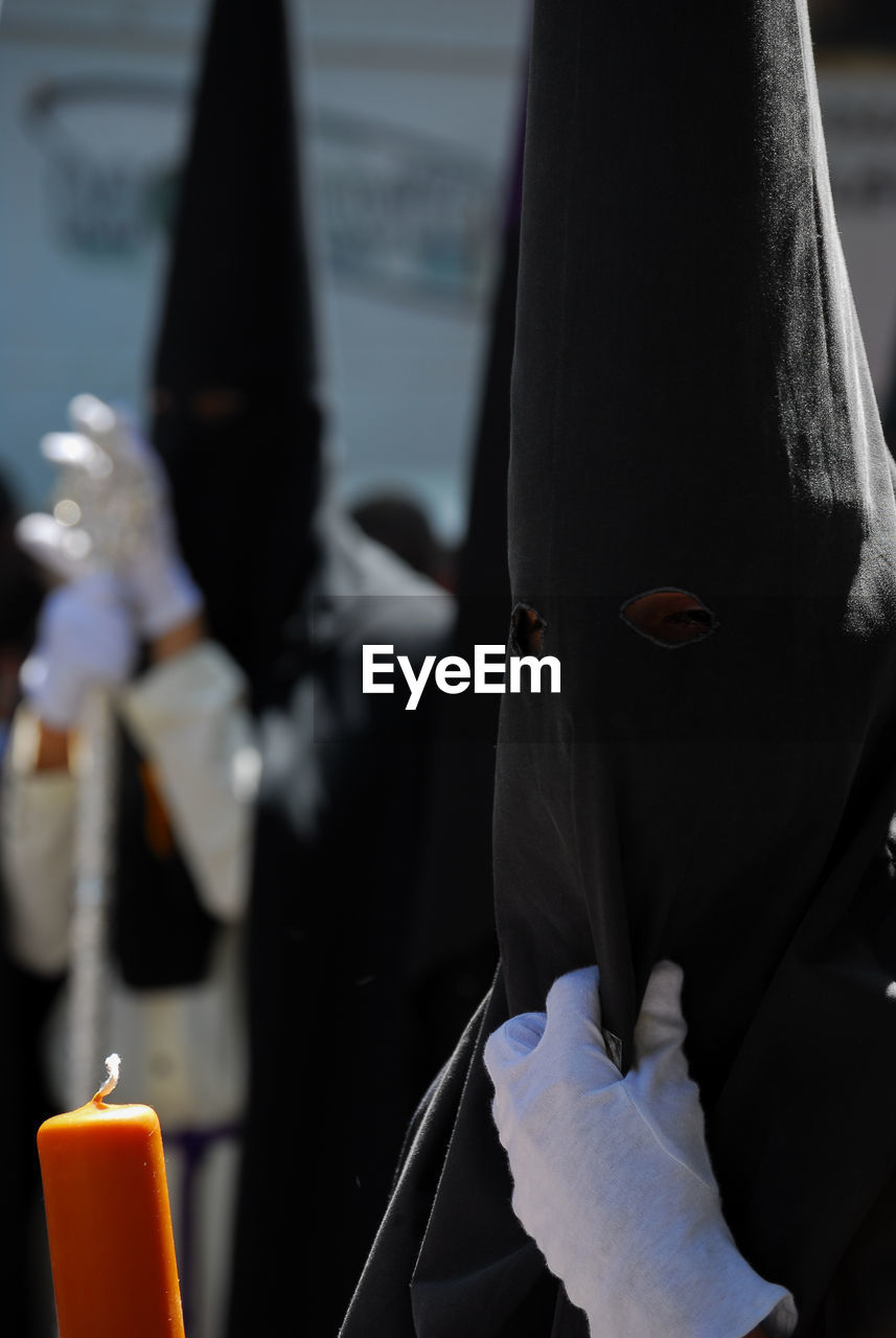 People wearing traditional clothing marching on street in city