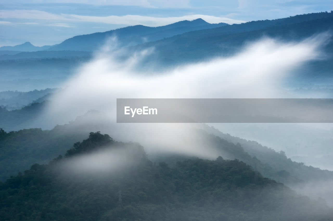 Sunrise over the mountain range, beauty rainforest landscape with fog in morning.