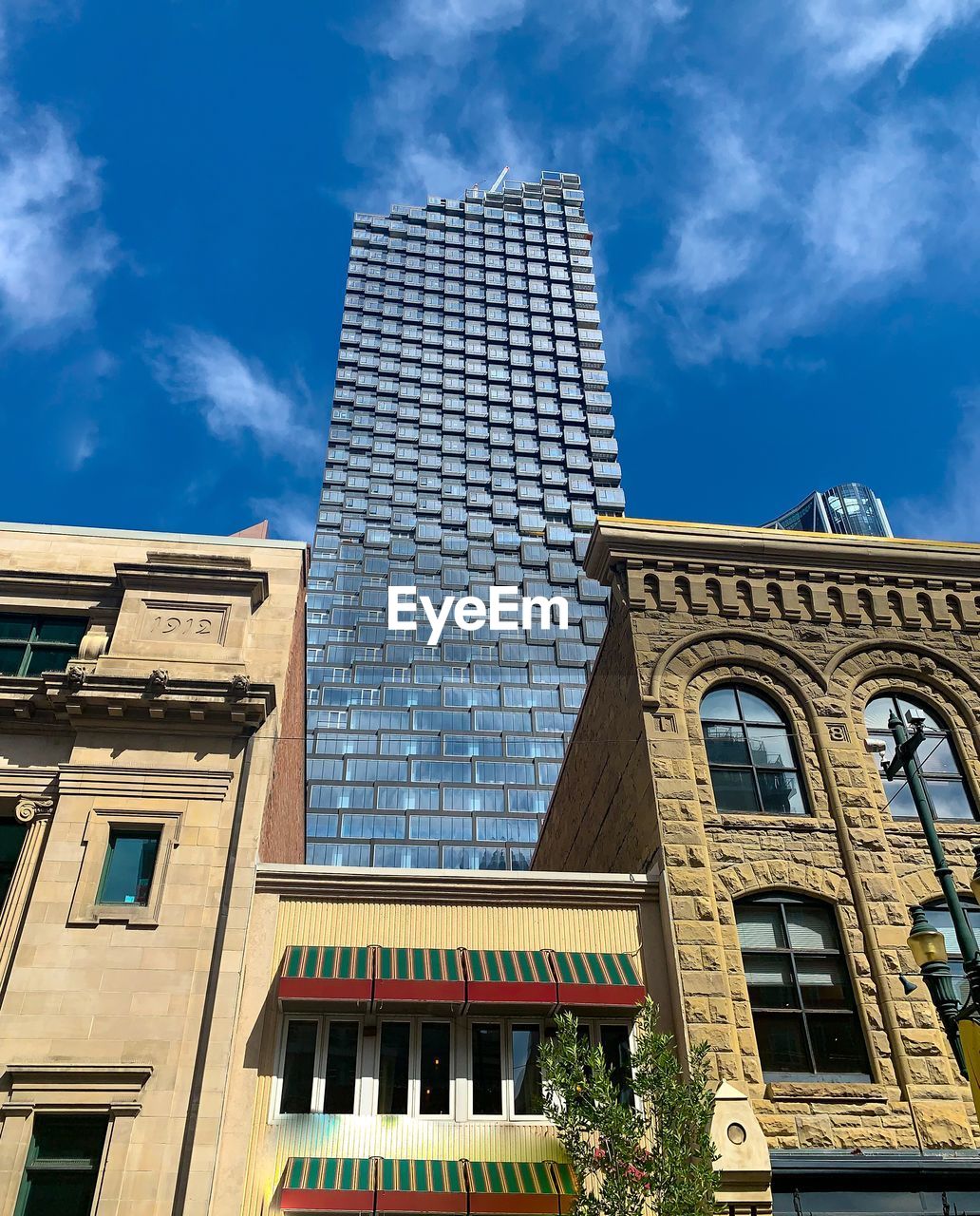 Low angle view of modern building against blue sky