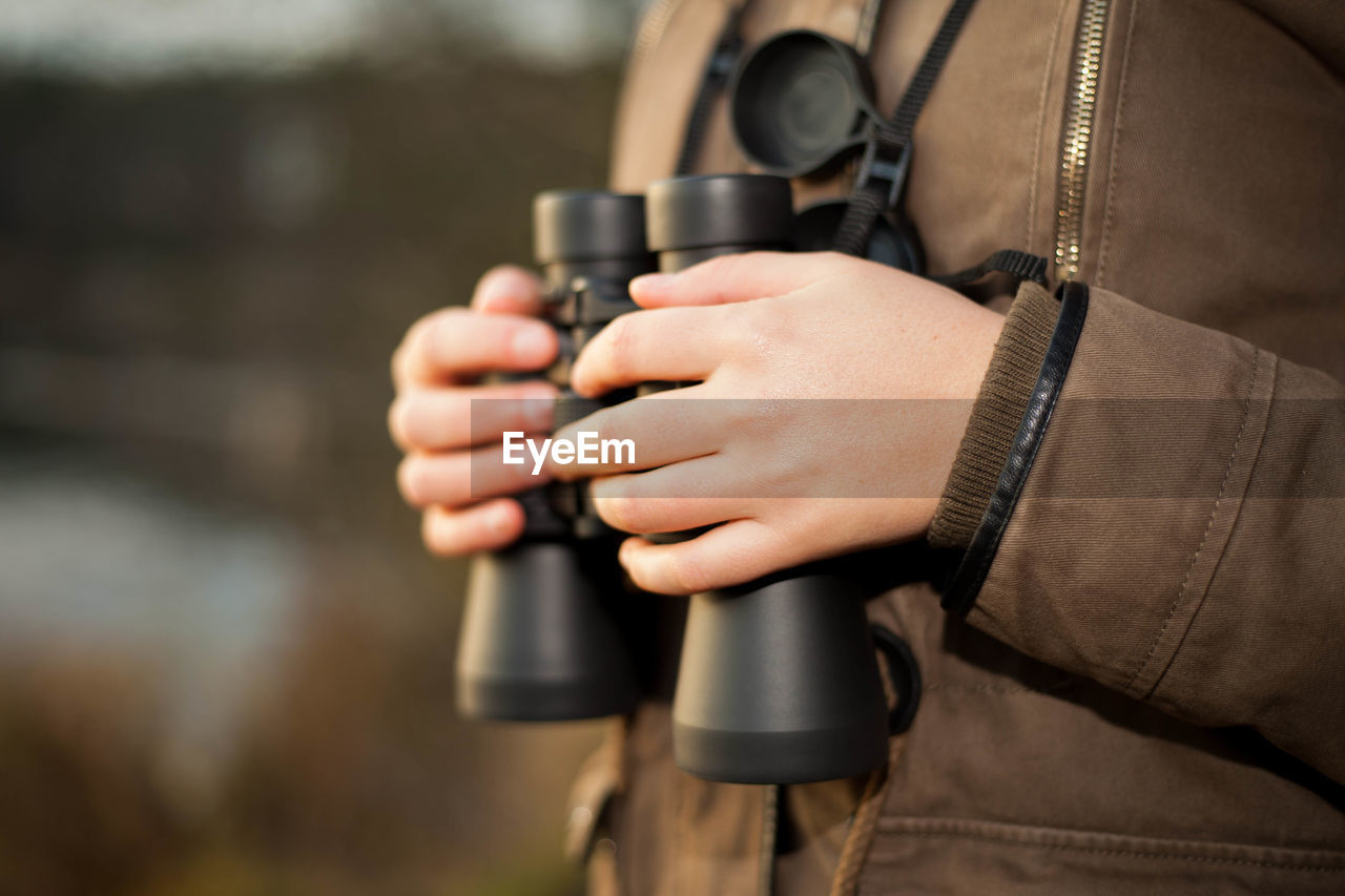 Close-up of man holding camera