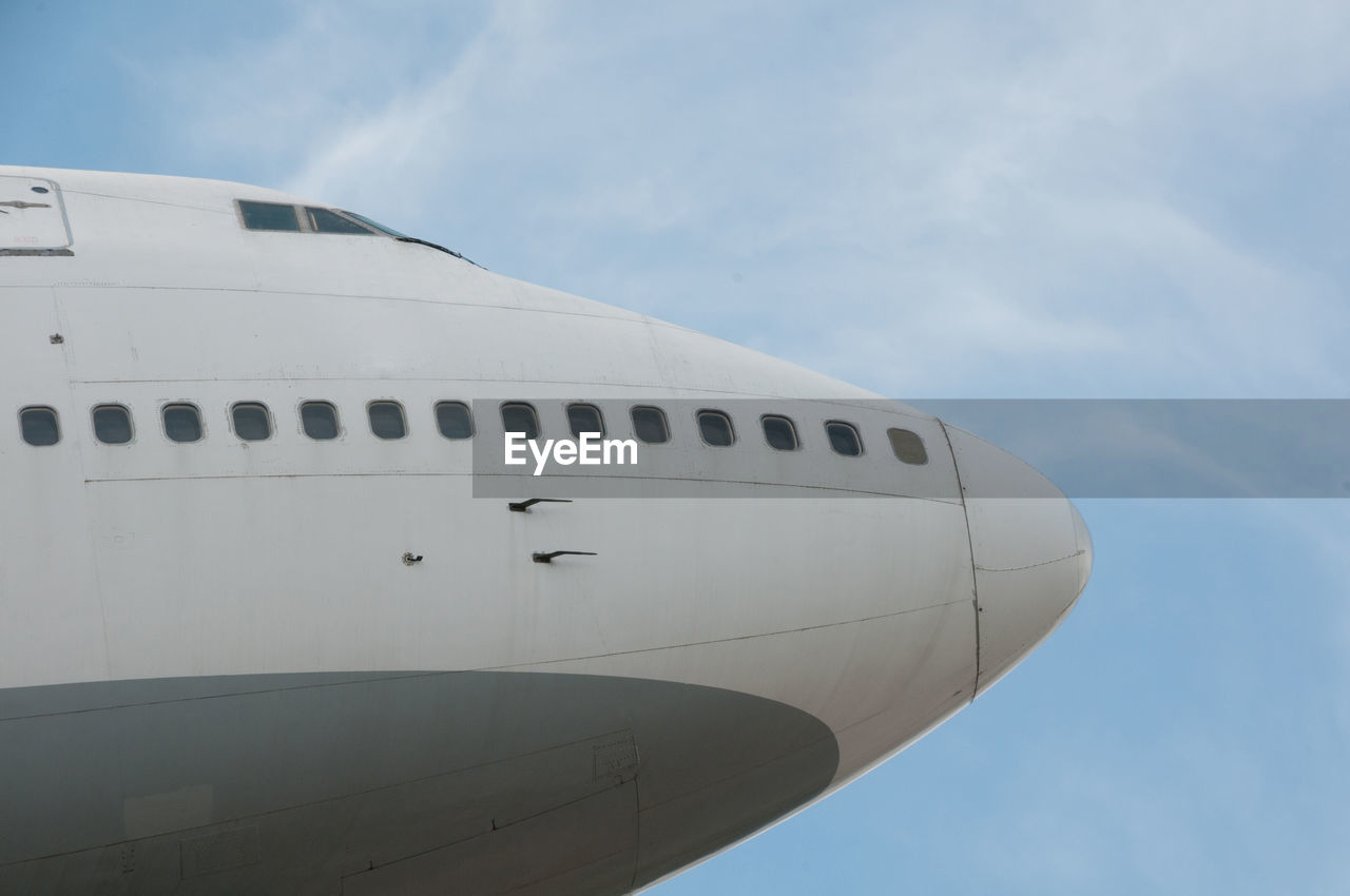 Cropped image of airplane flying against sky