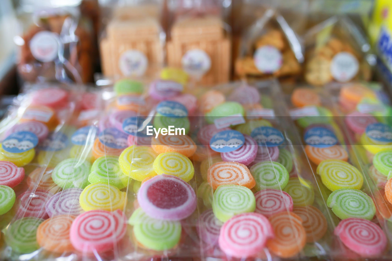 multi colored, dessert, food, variation, large group of objects, no people, abundance, close-up, sweetness, in a row, indoors, food and drink, sweet food, sweet, selective focus, retail, store, business finance and industry, still life, business, for sale