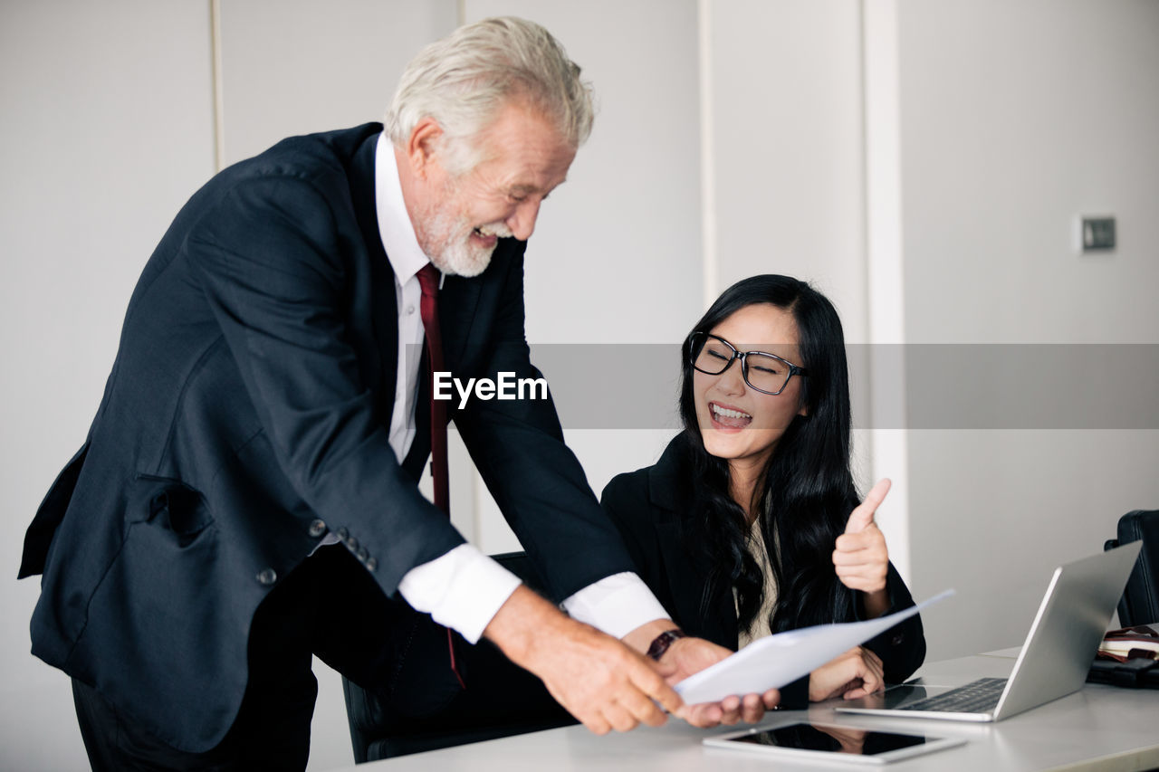 TWO PEOPLE WORKING IN A LAPTOP