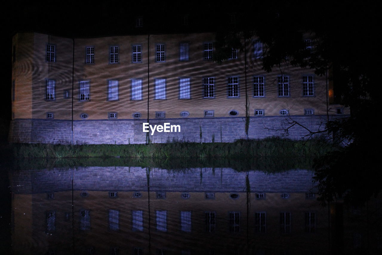 REFLECTION OF ILLUMINATED BUILDINGS IN WATER