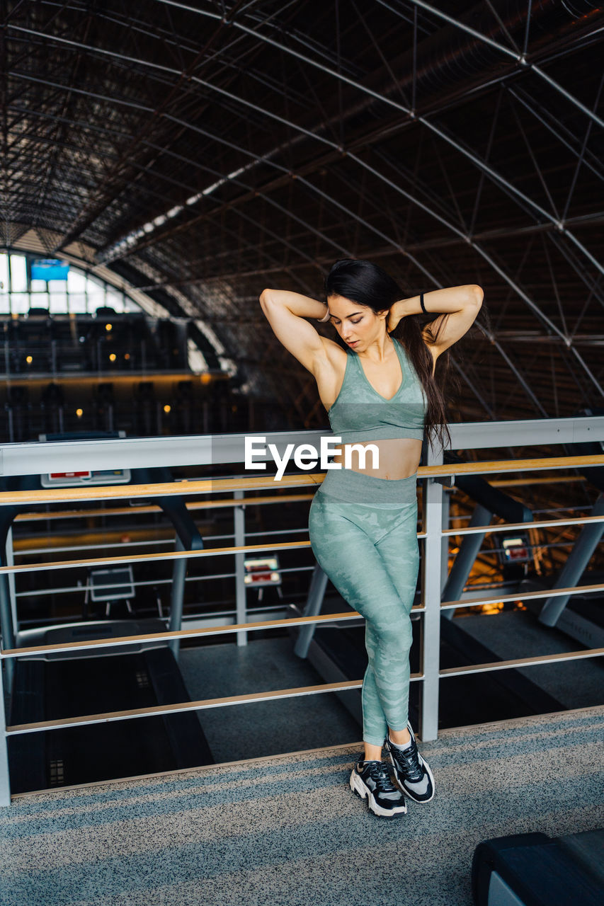 Side view of young man exercising in gym