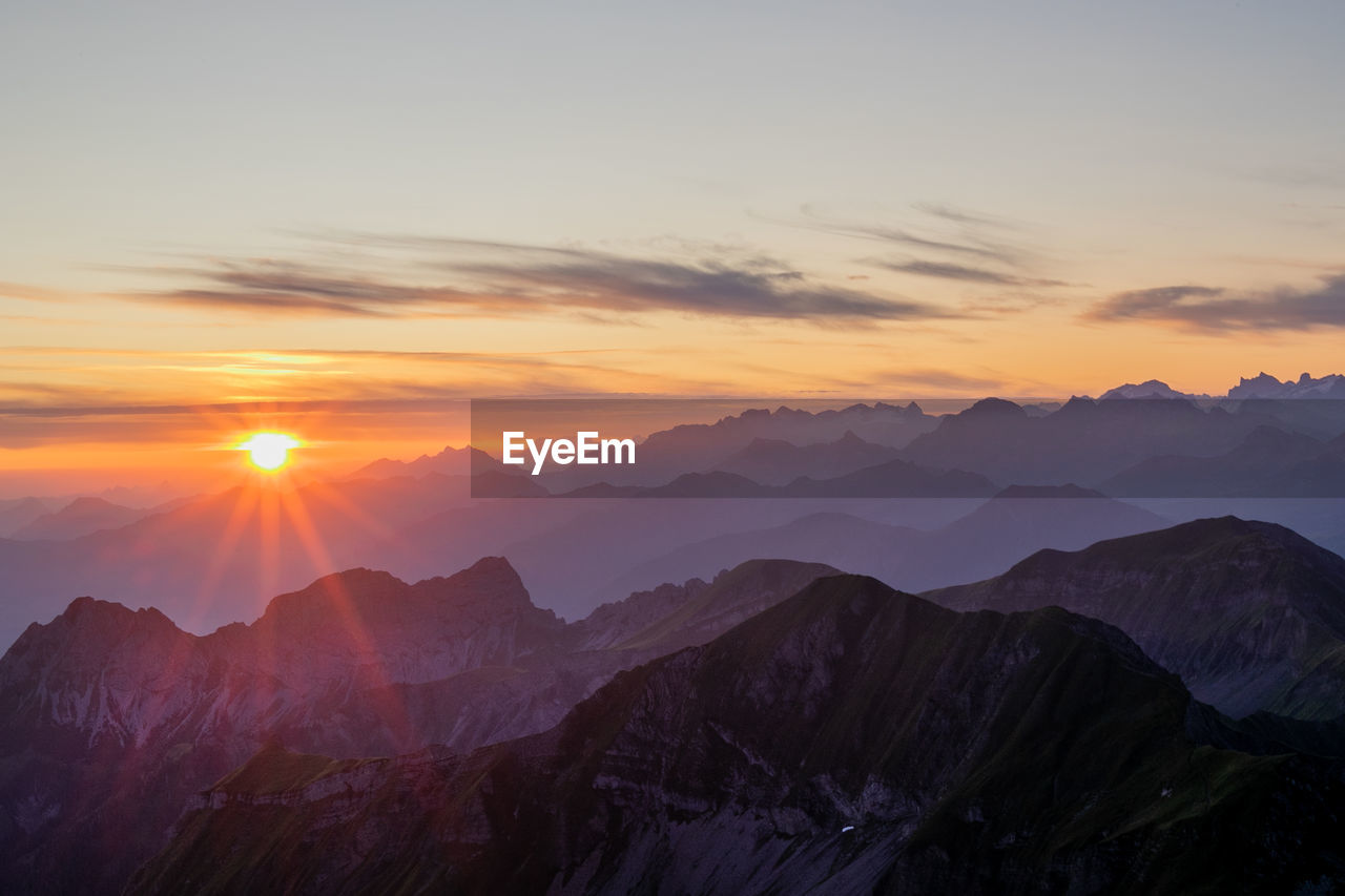 Scenic view of mountains against sky during sunset