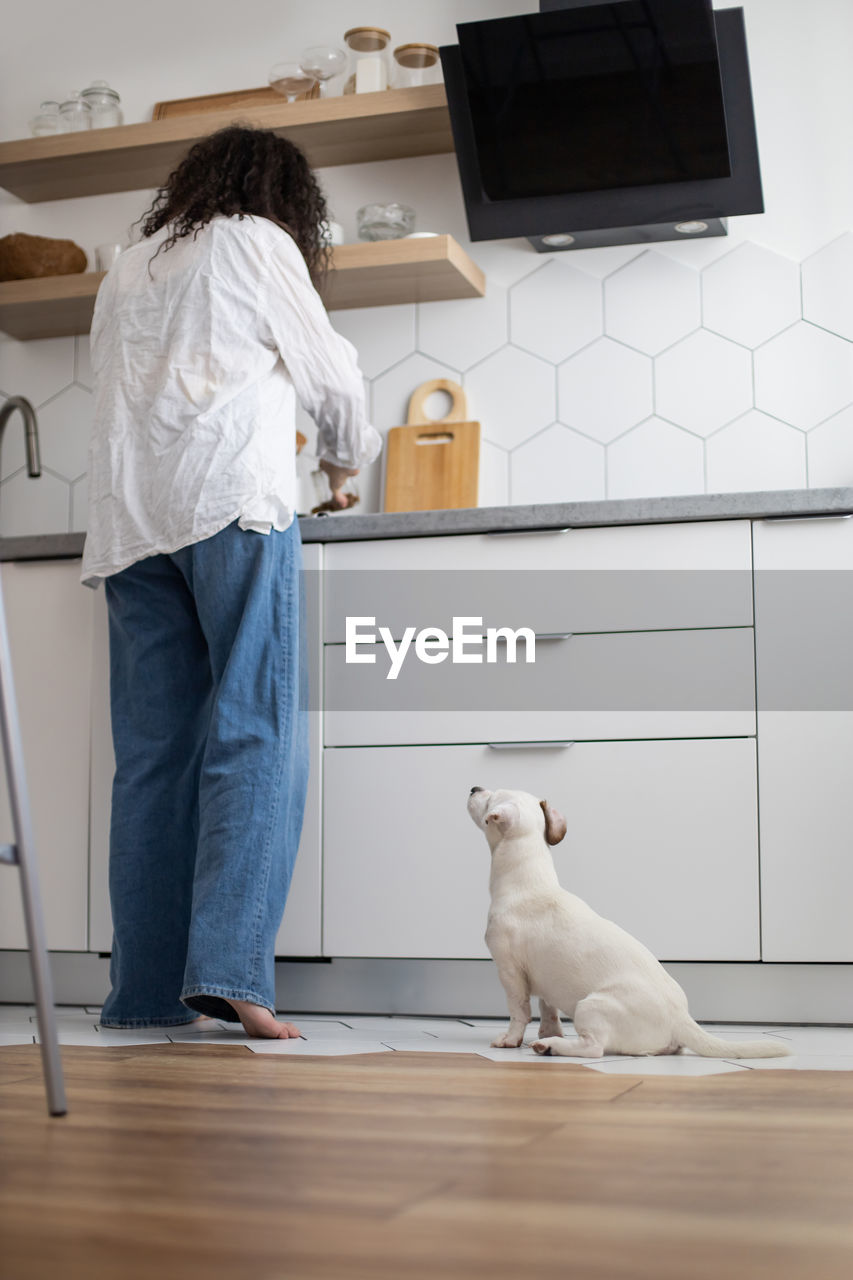 Rear view of man standing at home