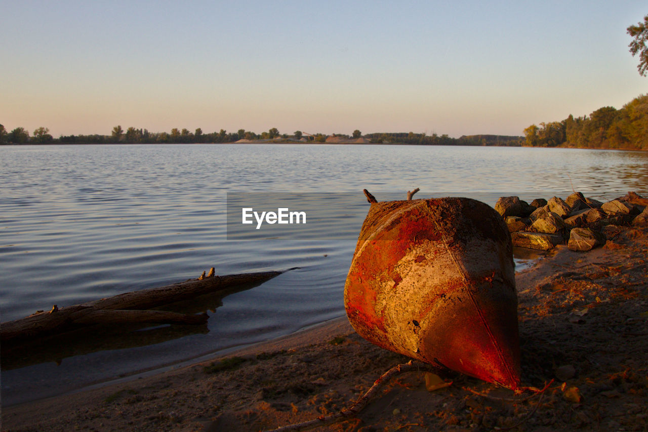 Scenic view of sea against clear sky and buoy 