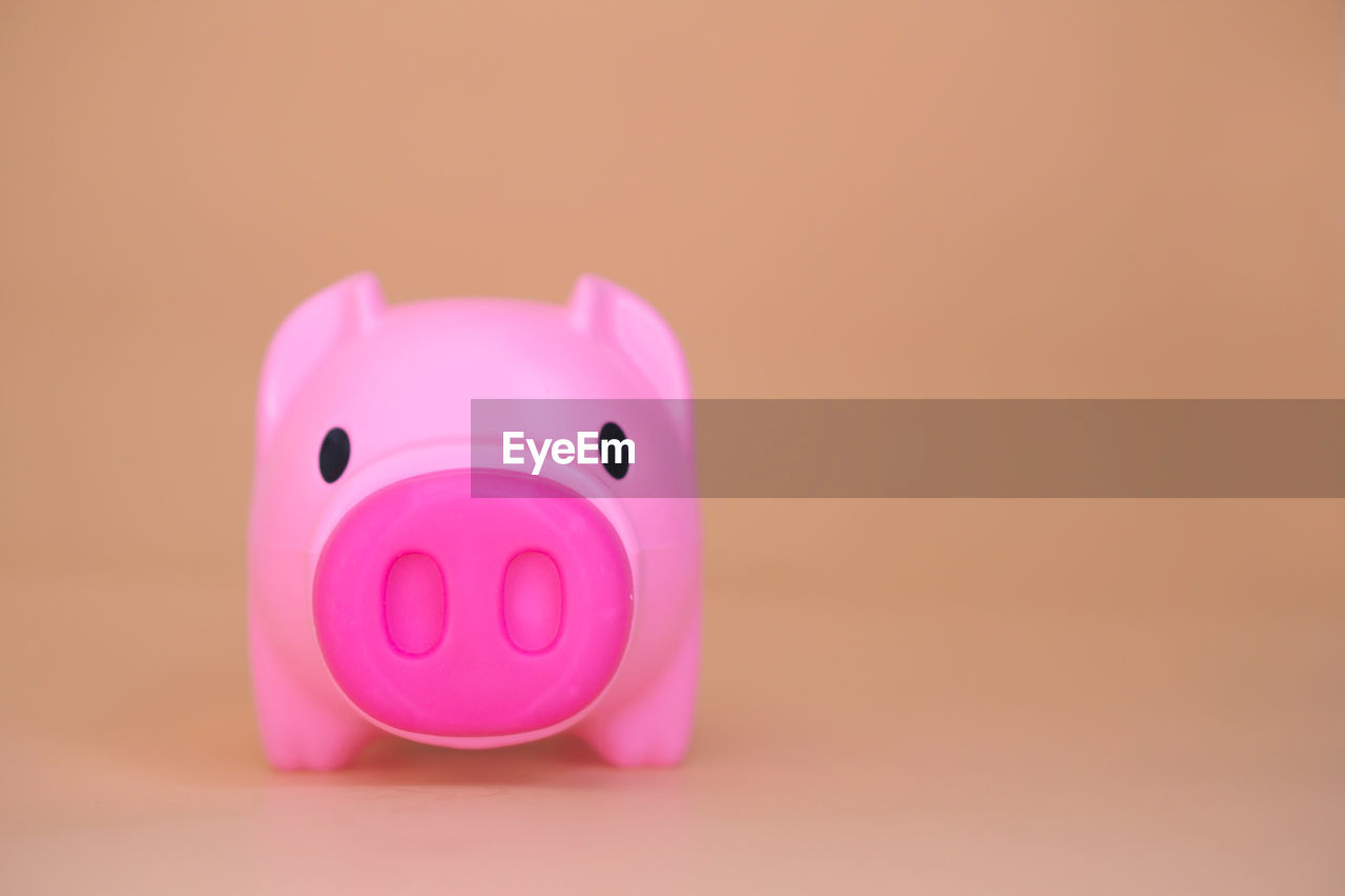 Close-up of pink candle against black background