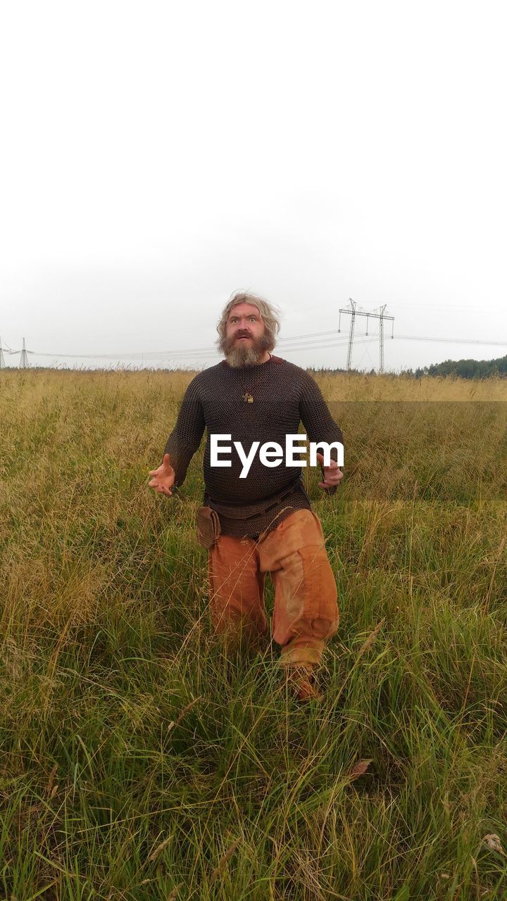 PORTRAIT OF MAN ON FIELD