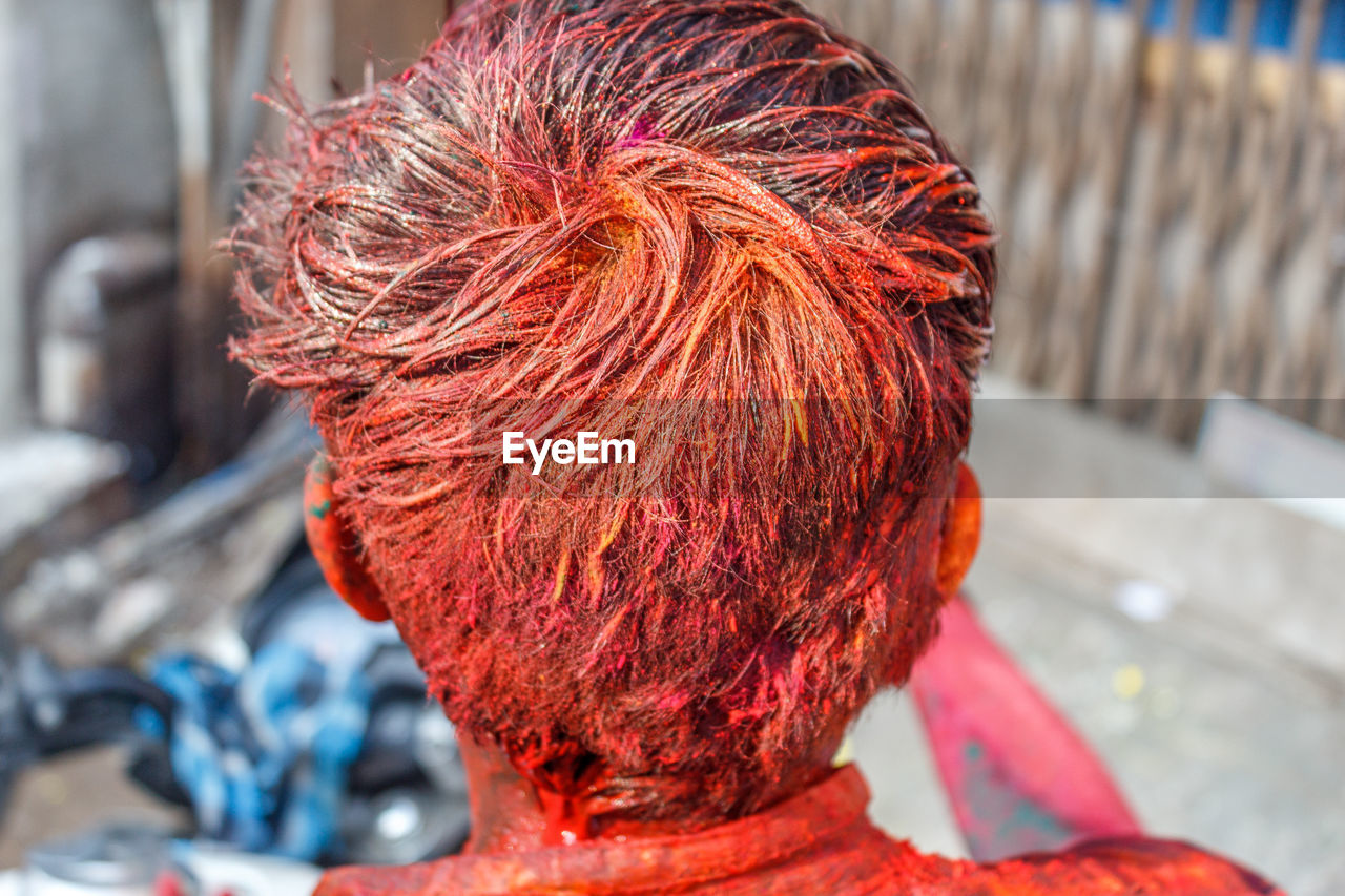 Rear view of man with color during holi