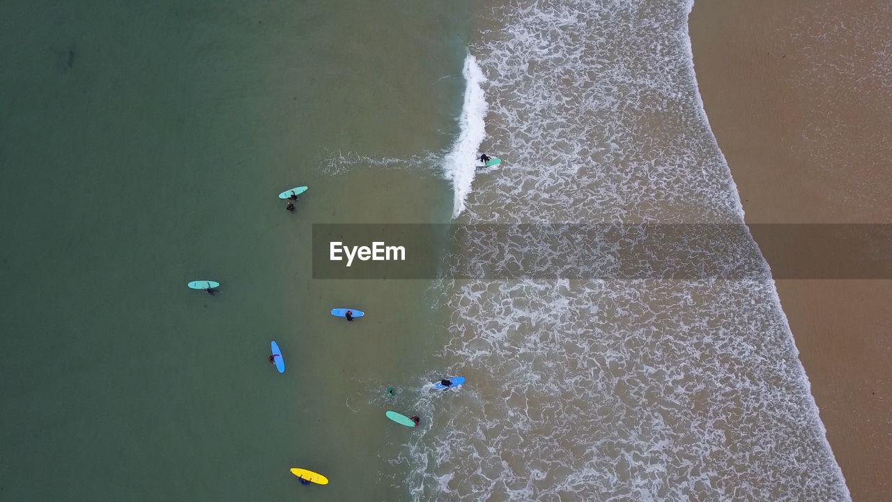 HIGH ANGLE VIEW OF MAN ON BEACH