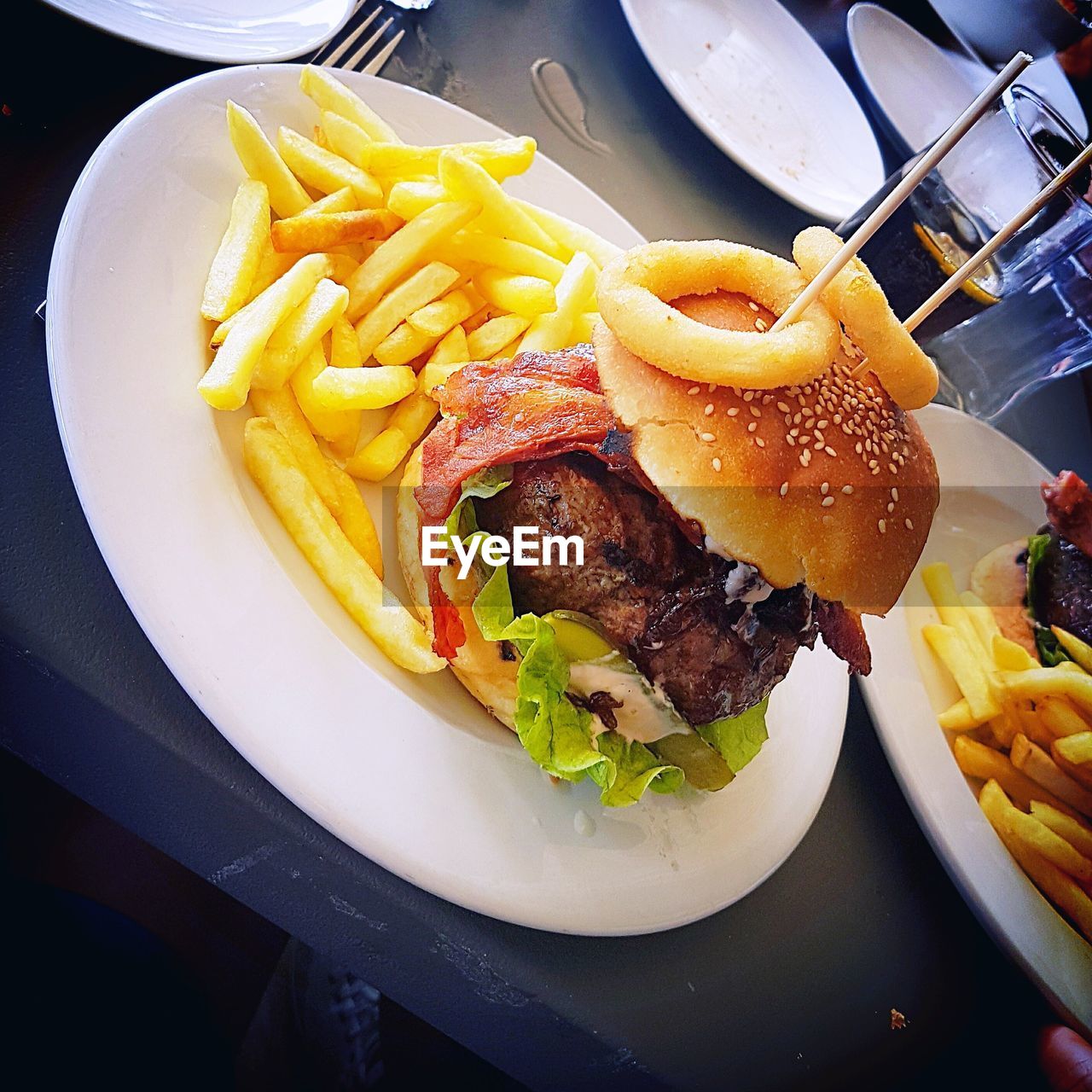 High angle view of burger and french fries in plate on table