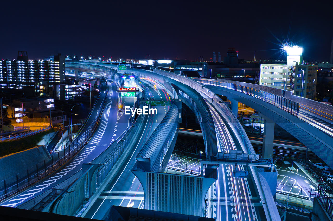 High angle view of highway and buildings in city at night