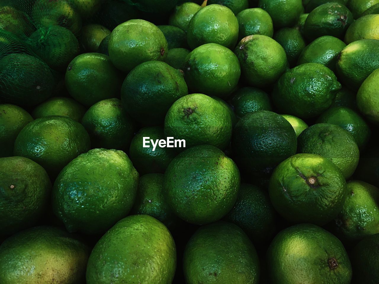 Full frame shot of green limes in market