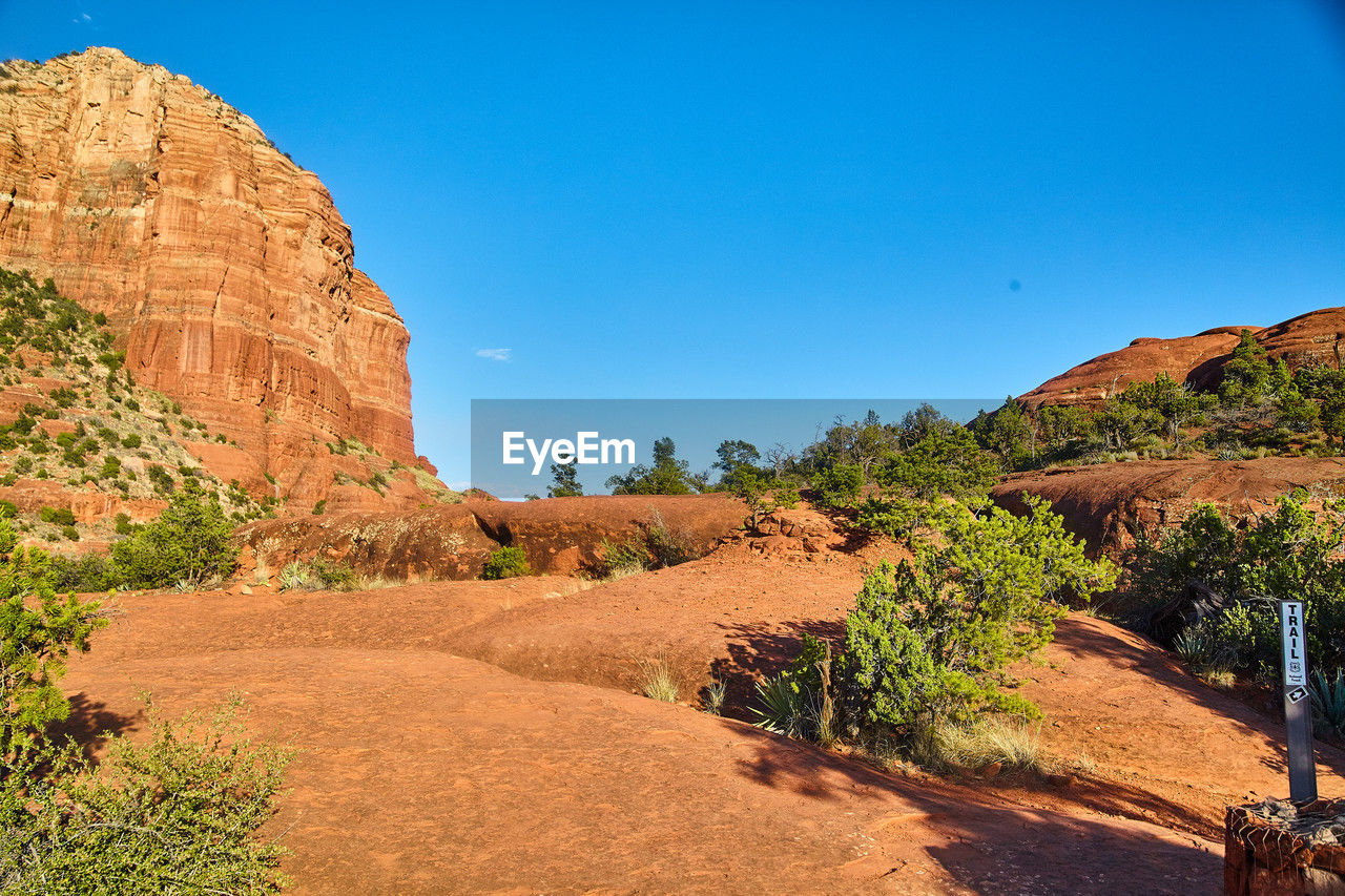 panoramic view of rock formations against clear blue sky