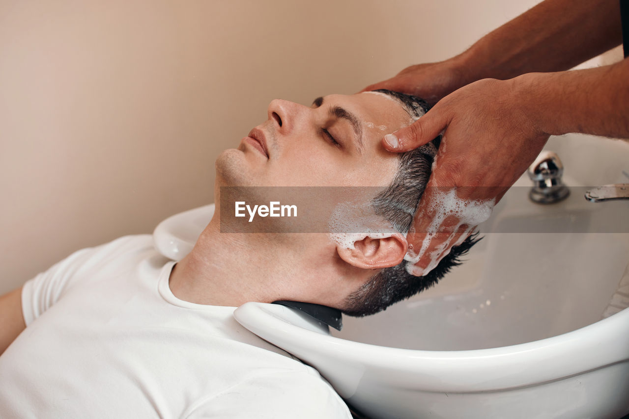 side view of senior man washing hands