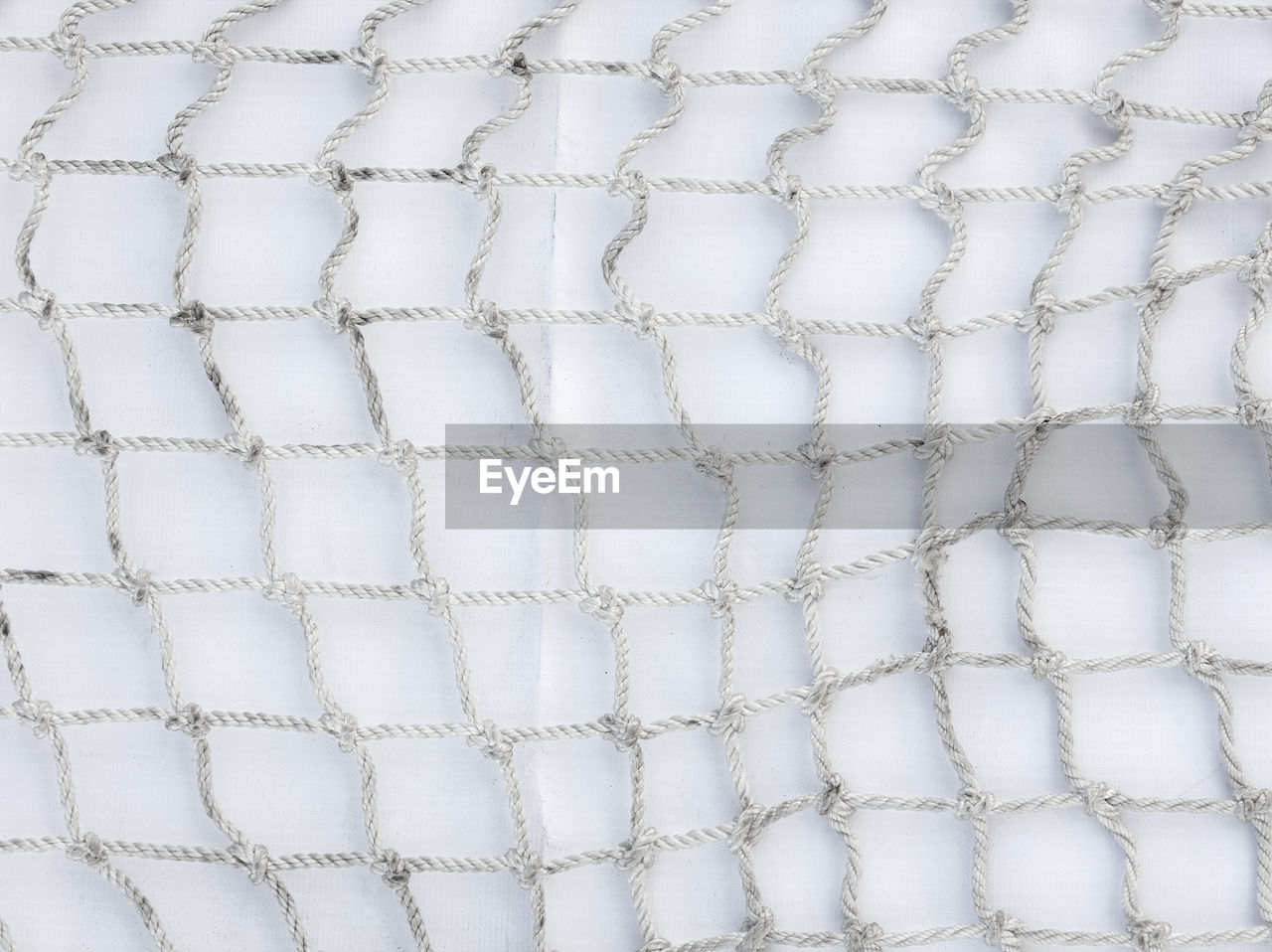 Full frame shot of net against wall
