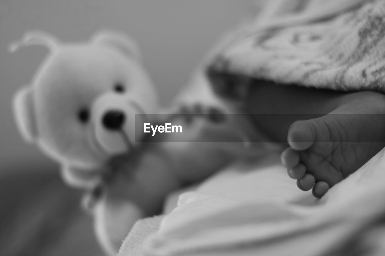 CLOSE-UP OF CUTE BABY HAND ON FABRIC