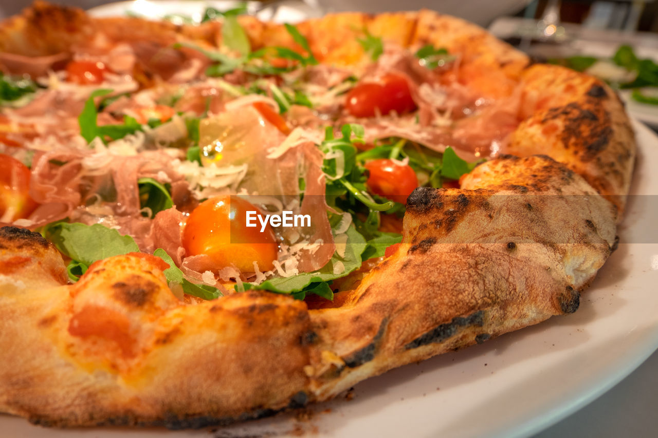 CLOSE-UP OF PIZZA WITH SAUCE IN PLATE