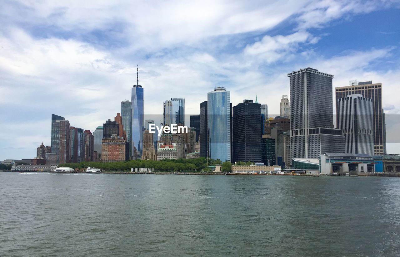 River by buildings against sky in city