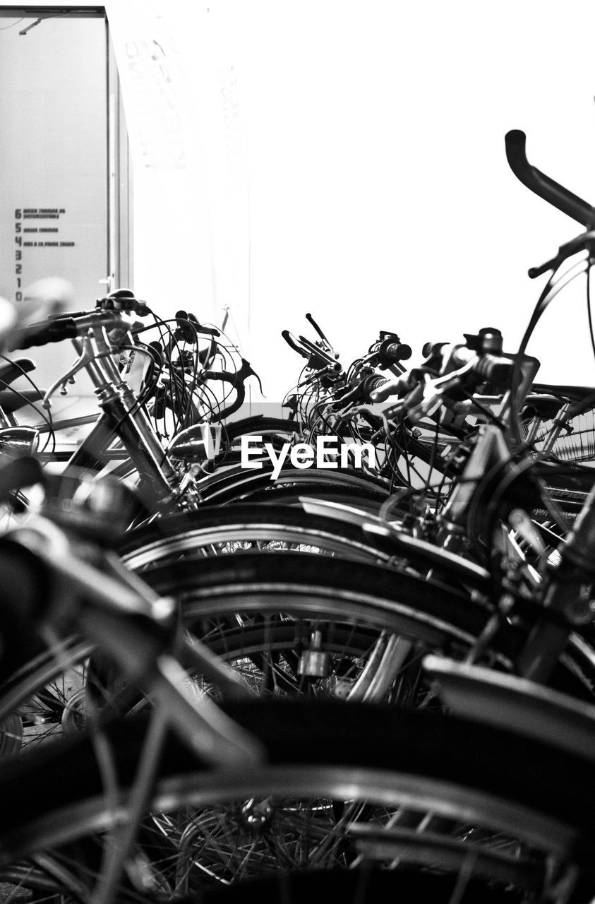 Bicycles parked in parking lot against wall