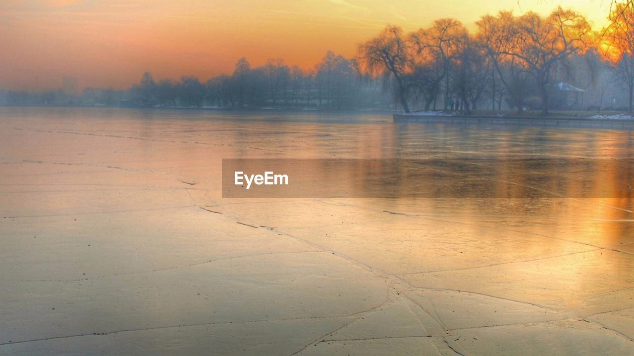 SCENIC VIEW OF LAKE DURING SUNSET