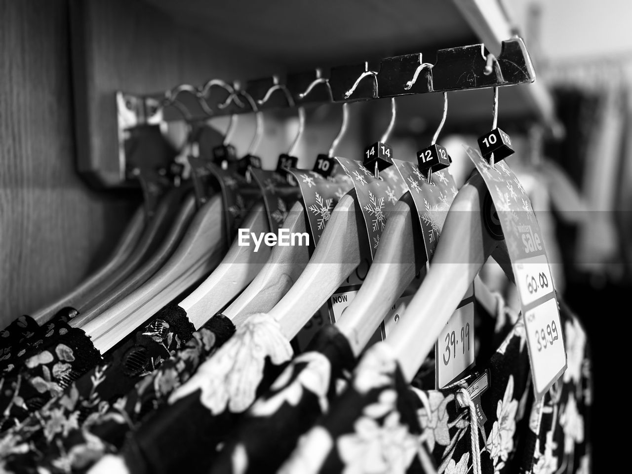 black, hanging, white, black and white, coathanger, retail, store, monochrome, monochrome photography, clothing, fashion, in a row, shopping, no people, variation, selective focus, large group of objects, clothes rack, rack, clothing store, indoors, sale, consumerism, abundance, business, close-up, business finance and industry, for sale, focus on foreground