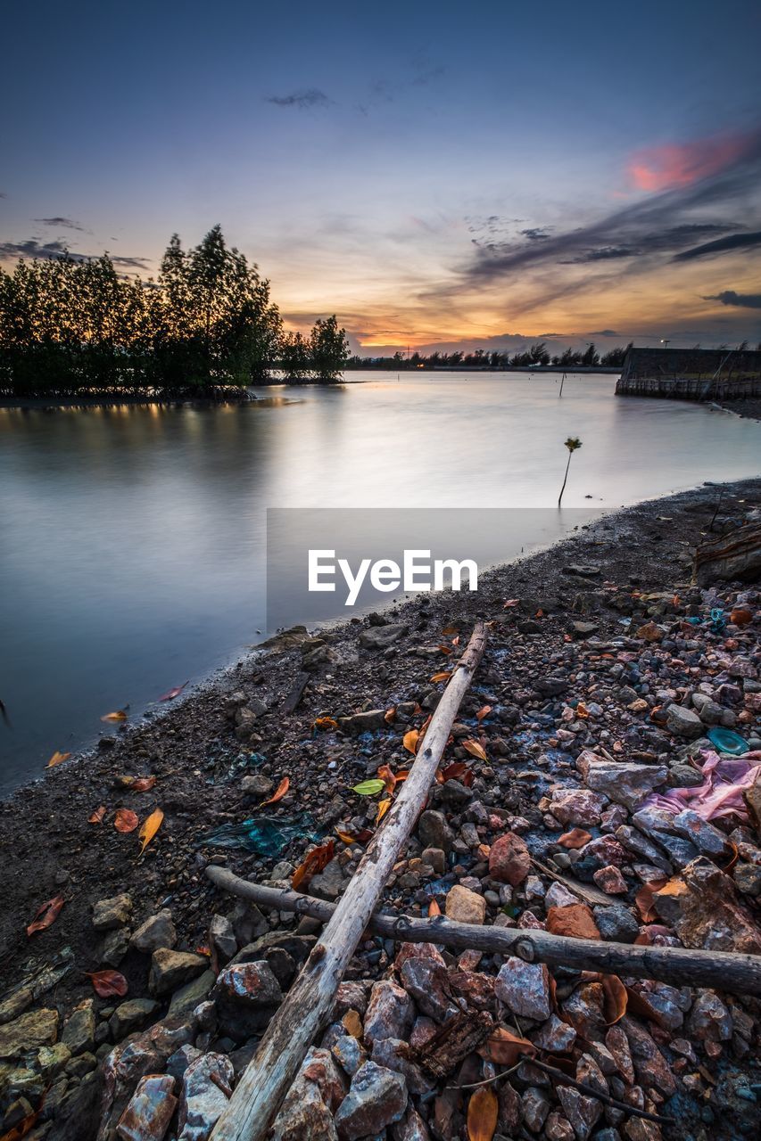 SCENIC VIEW OF LAKE AT SUNSET