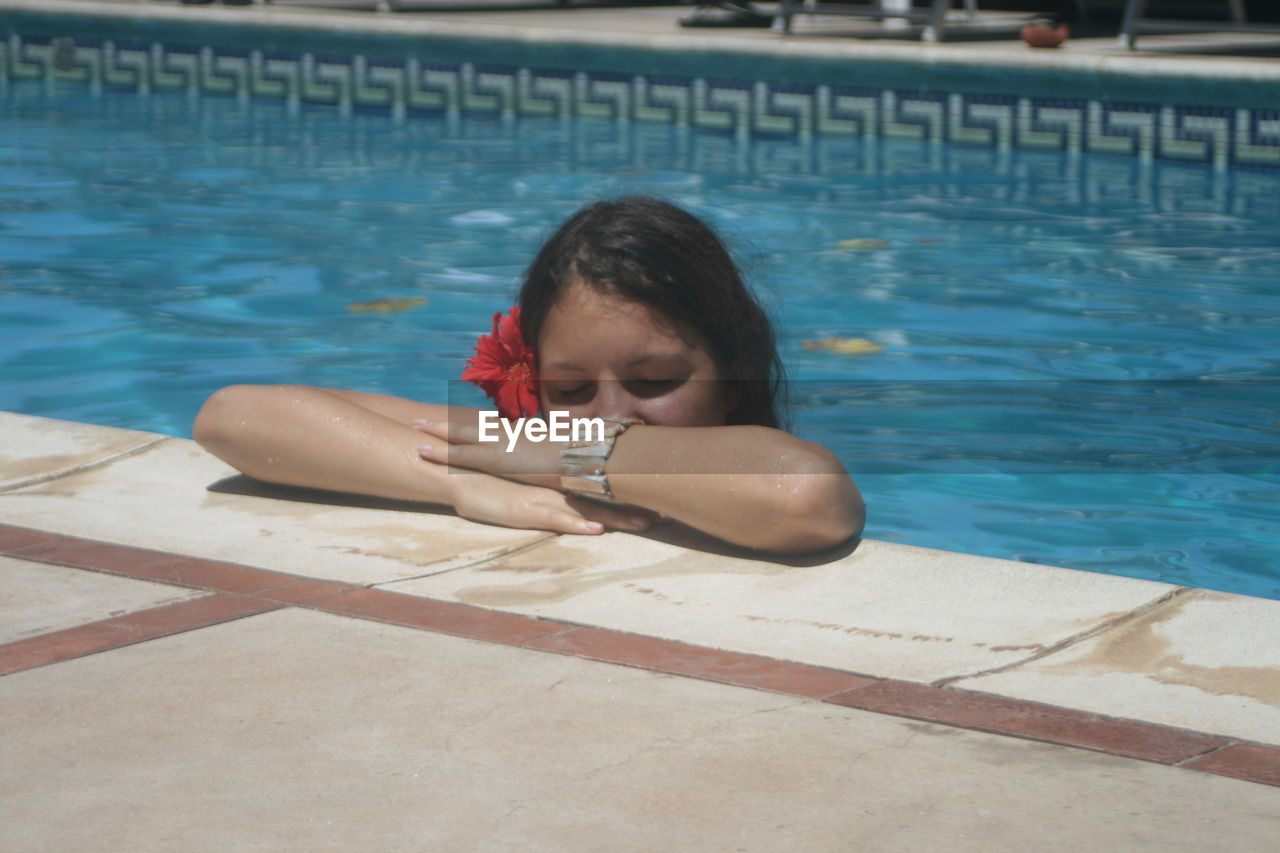 YOUNG WOMAN STANDING IN WATER